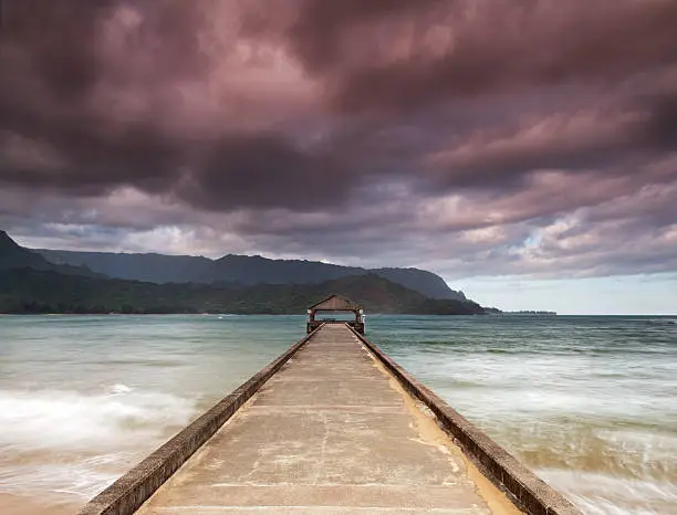 Hanalei pier and morning clouds on famous Hanalei Bay, island of Kauai, Hawaii.