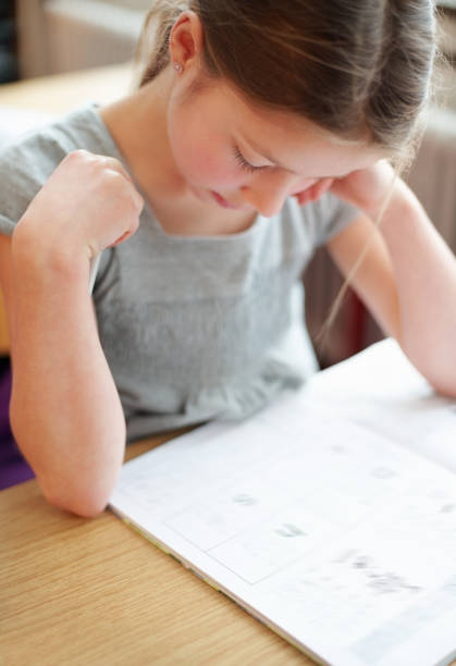 istock Little girl at school concentrating on her studies 154934027