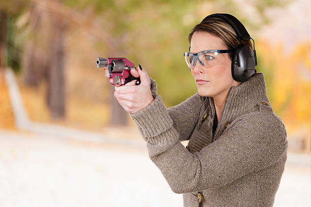 istock Woman Pointing a Gun 154934105