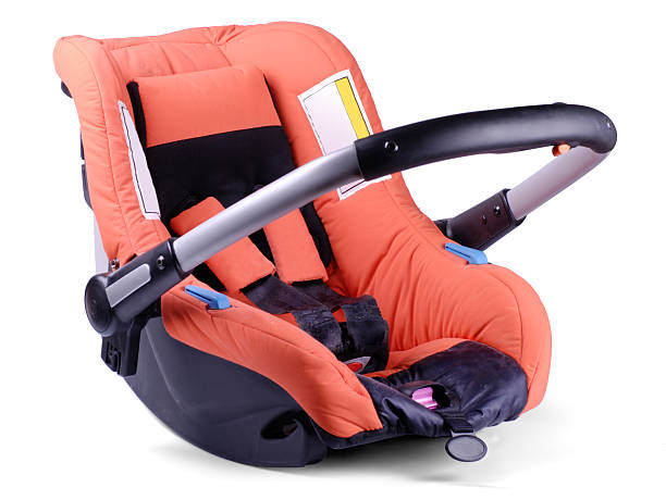 Baby car and travel seat on white background Orange baby car seat, isolated on white. baby carrier stock pictures, royalty-free photos & images