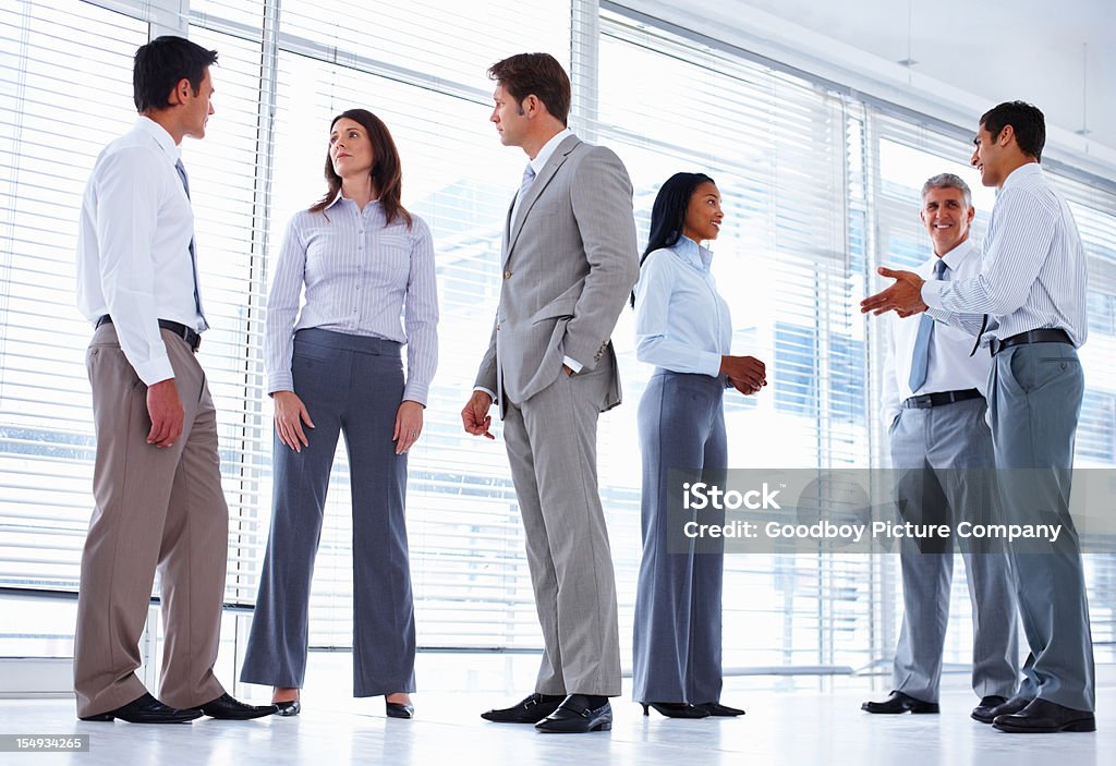 Business professionals stand in office setting  Administrator Stock Photo