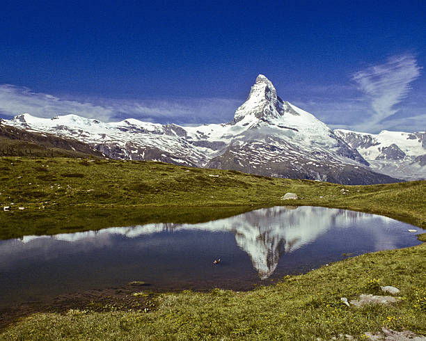 The Matterhorn Reflected in Leisee The Matterhorn (14,692') in the Pennine Alps on the border between Switzerland and Italy is probably one of the most recognizable mountains in the world. This reflection of the Matterhorn was taken from Leisee above the town of Zermatt in Valais Canton in Switzerland. jeff goulden switzerland stock pictures, royalty-free photos & images