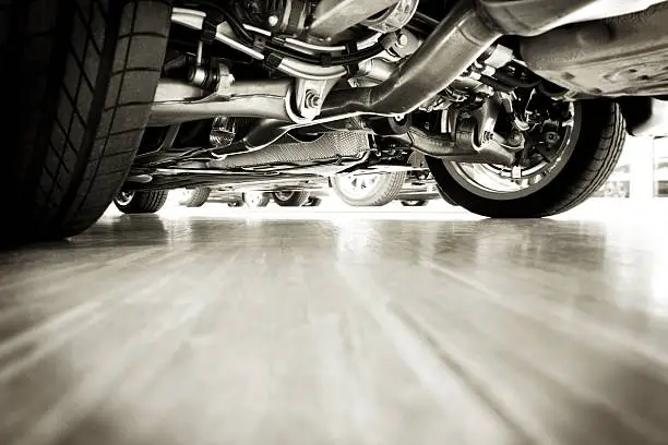 close up rear shot of a new sports car. The technique is noticeable, everything is new and shiny. It is possible to see wide tires, a blanc exhaust pipe, the brake system, a part of the transmission, the shock absorbers and a part of the tank. The lower space of the picture can be used as a copy space. There are more cars, technique and vans in my portfolio.