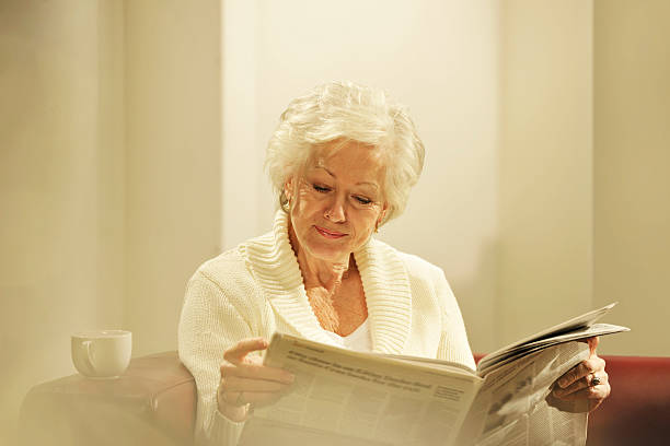 istock senior woman reading newspaper 154934987