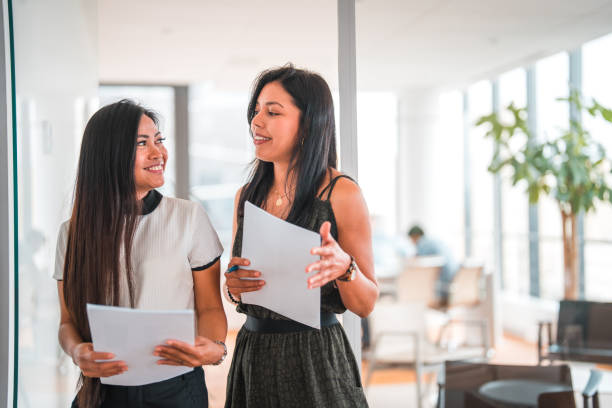 istock Two Female International Business Developers Discussing At Work 1549446260