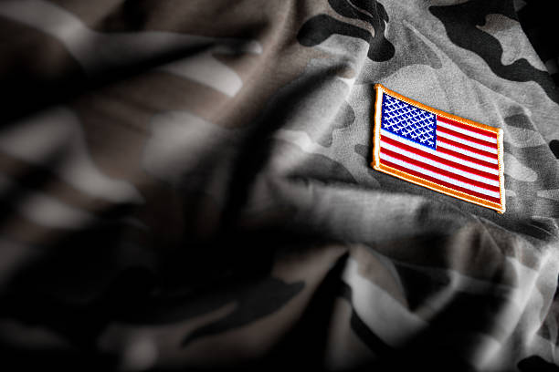American Flag and Camoflage (Military Series) American flag patch on camoflage military uniform stock pictures, royalty-free photos & images