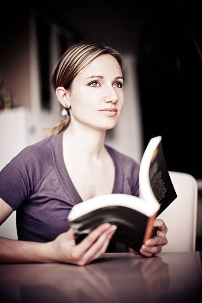 istock Young woman reading a book 154945317