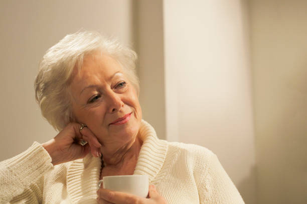 istock senior woman with hot drink 154945331