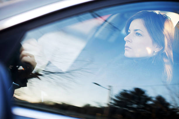 istock Beautiful woman is driving a car. Side view. 154945599