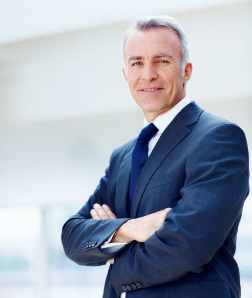 istock Business executive standing with arms folded 154945618