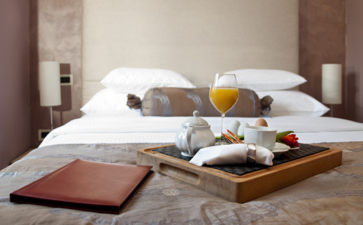 two white pillows on bed with lamp light at night in bedroom