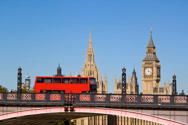 London, UK - 02 May 2024: Double-decker buses and black cabs on Westminster bridge with Big Ben tower at background