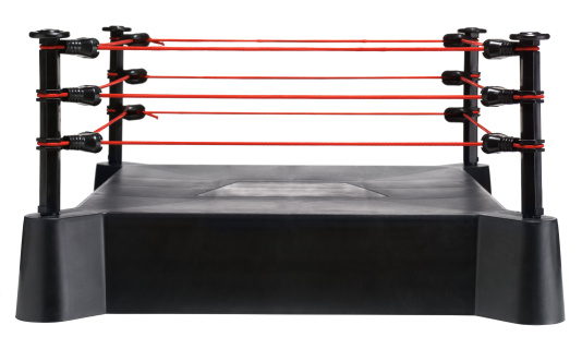 Toy boxing ring with red ropes.  Isolated on white.