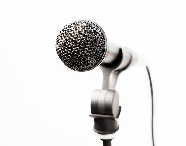 Microphone on white background. Horizontal composition with copy space. High angle view.