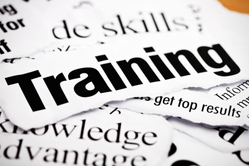 Close up on newspaper headlines about training, knowledge, skills and their value in business.