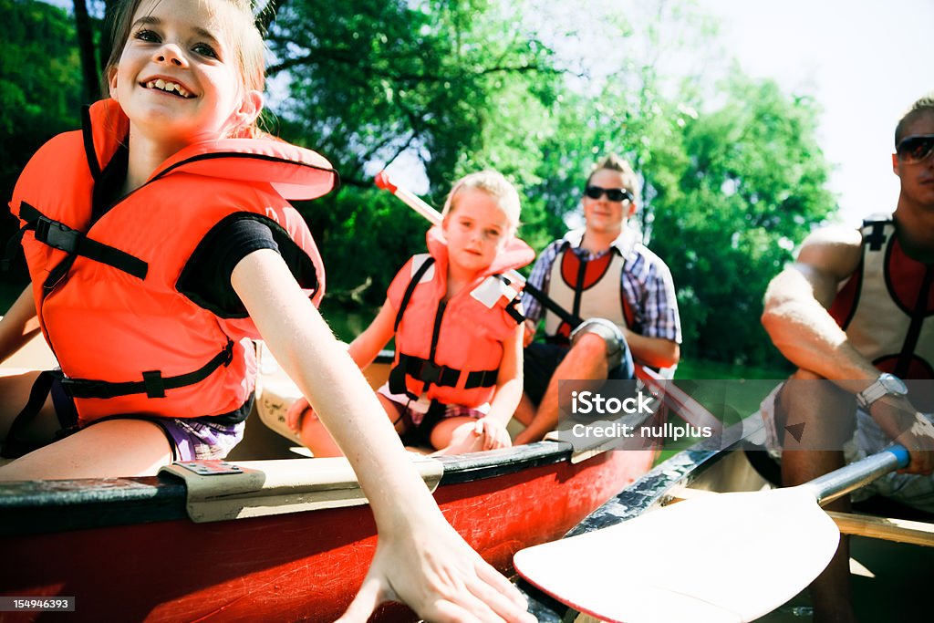 Joven familia paseos en canoa - Foto de stock de Piragüismo libre de derechos