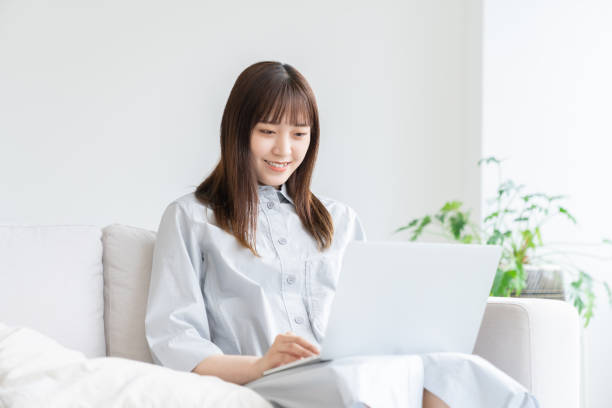 young asian woman using laptop stock photo