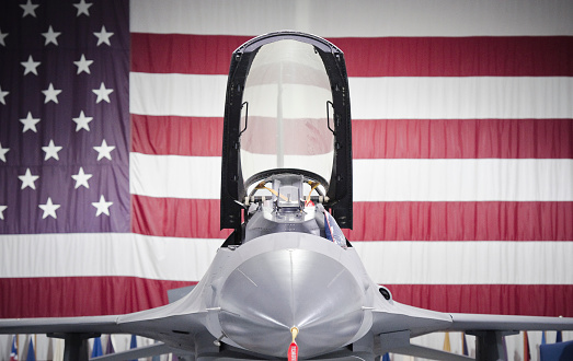 Fighter PLane with USA Flag Behind it.