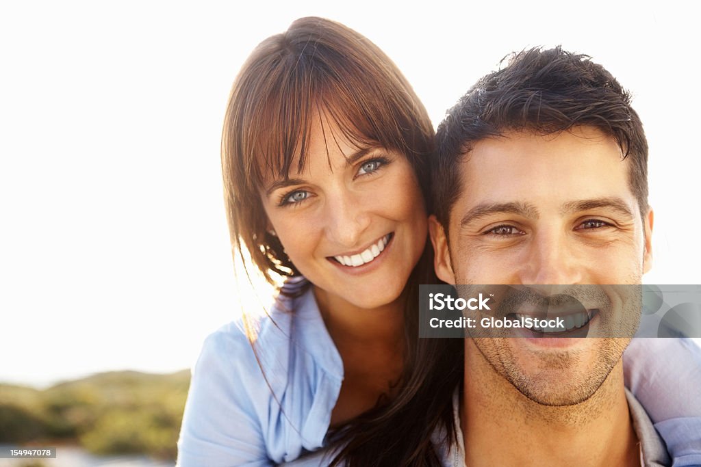 Young couple embracing Closeup portrait of a happy couple smiling - outdoors 20-29 Years Stock Photo