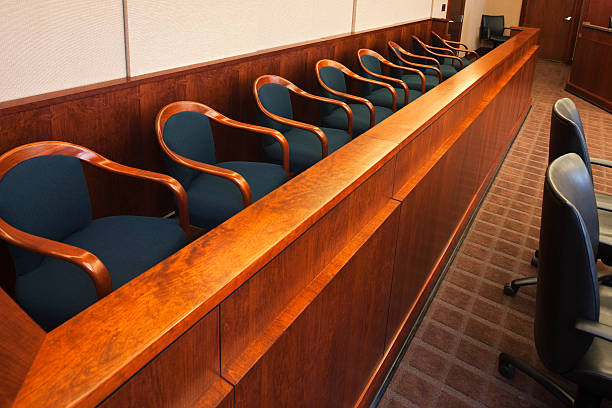 Empty seats in the jurors row in the court room stock photo