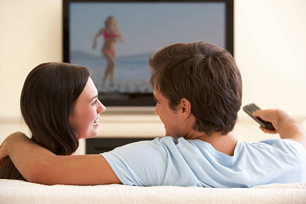 istock Couple Watching Widescreen TV At Home 154947485