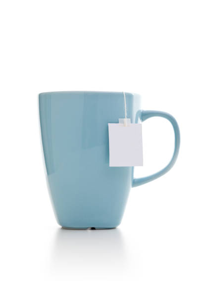Tea bags in mug on white background