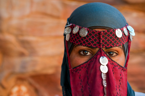 A 24-year-old Bedouin woman outdoors in Petra, Jordan, wearing a traditional veil