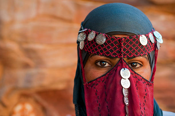 Veiled Bedouin woman in Jordan A 24-year-old Bedouin woman outdoors in Petra, Jordan, wearing a traditional veil bedouin photos stock pictures, royalty-free photos & images