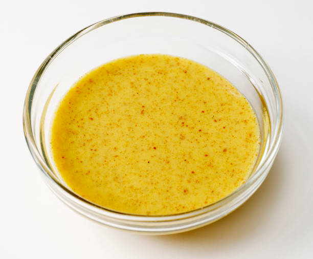 istock Small Glass Bowl Containing Mustard Vinaigrette Salad Dressing 154947937