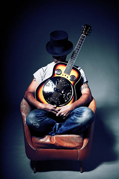 istock Man with guitar and top hat 154948163