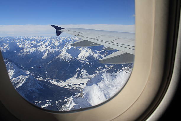 Flying over snow covered Austrian Alps mountain peaks