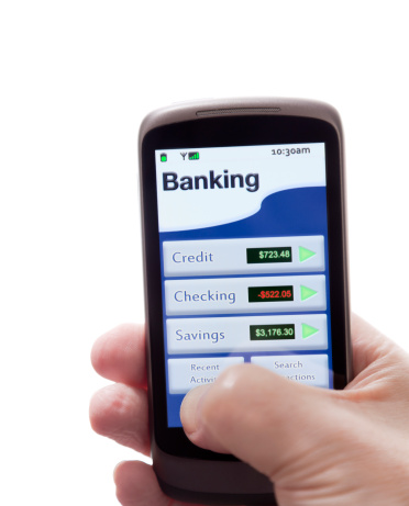 Mobile banking app on a smartphone showing Checking, Savings and Credit Card accounts.