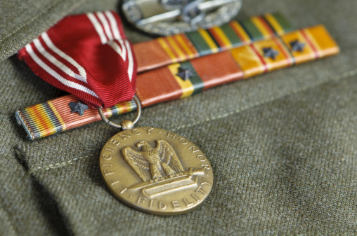 Authentic medals displayed on a US Army Ike jacket (short tunic) uniform from World War II.  Uniform displays medals and pins for Pacific Campaign, Liberation of the Philippines, Combat Medic, Good Conduct, WWII Victory along with bronze stars.  Soldier was part of the 33rd Infantry Division that fought on New Guinea, liberated the Philippines and occupied Japan during World War II.