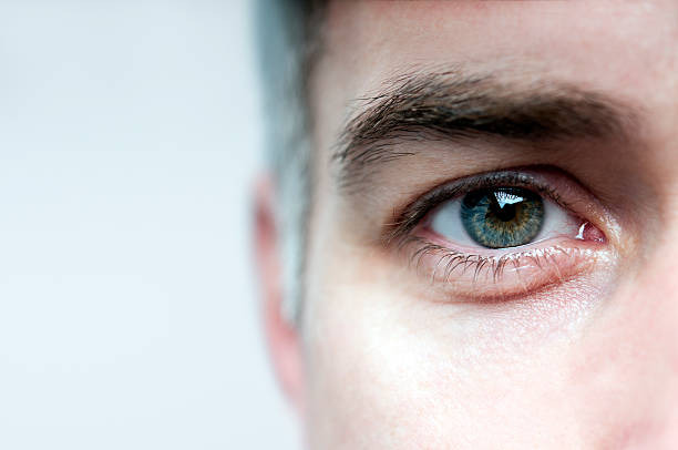 Look me in the eye Detail of a man's face blinking stock pictures, royalty-free photos & images