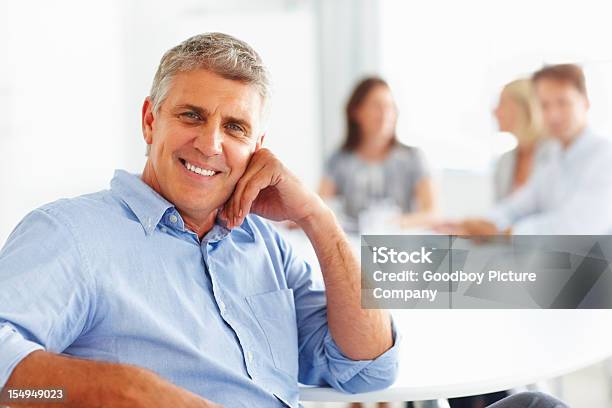 Smart Mature Businessman Smiling Stock Photo - Download Image Now - Relaxation, Seminar, Senior Adult