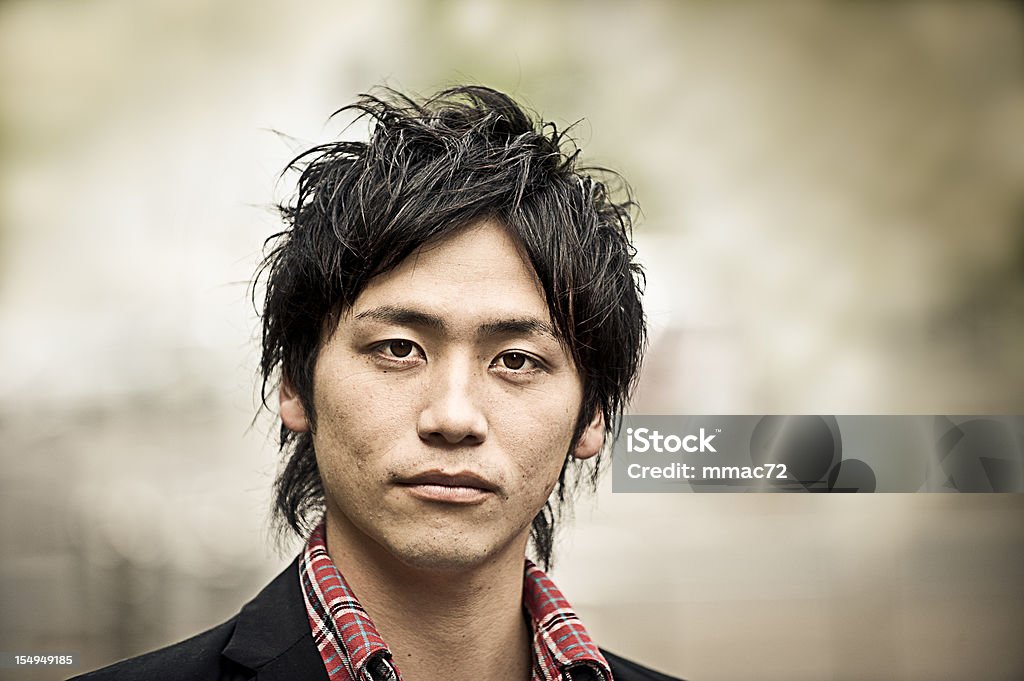 Tough Young Asian Guy Portrait Though Asian  Guy Portrait. The photo was post processed in order to emphasize the strong feature of the model plus desaturation, toning and vignetting. The photo was taken during the Tokyo iStockalypse Japan Stock Photo