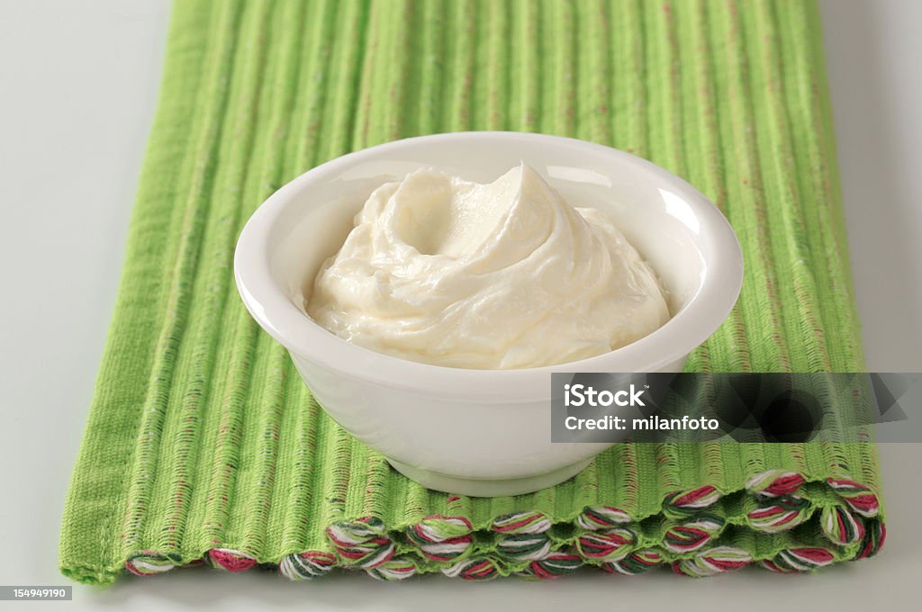 White bowl of cream cheese on green placemat Bowl of cream cheese Curd Cheese Stock Photo