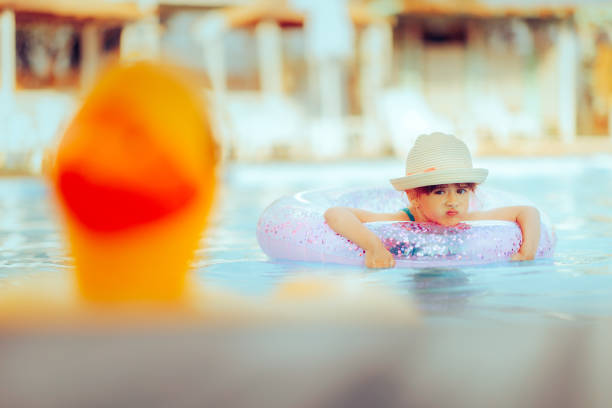 Bad mood toddler girl disliking her summer vacation being annoyed