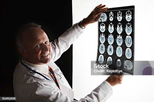 Doctor Turns Smiling From Cat Scan Good News Stock Photo - Download Image Now - Dark, MRI Scan, Adult