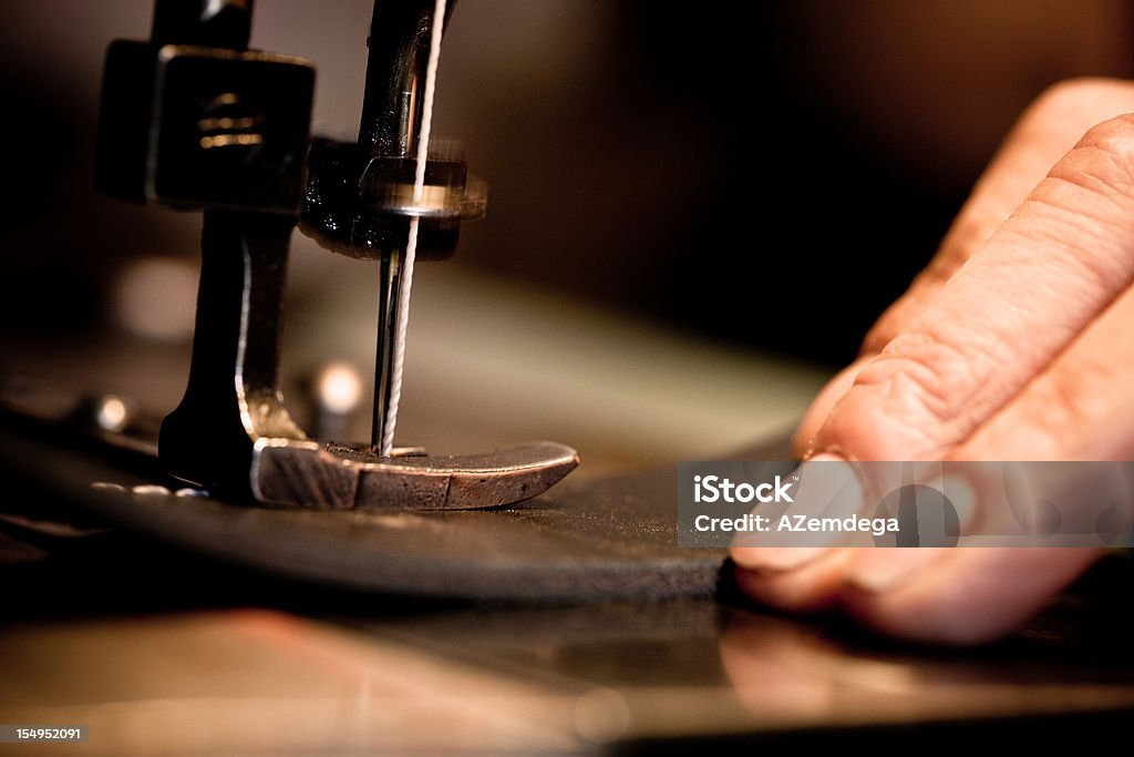 Sewing leather Worker sewing leather. Canon 1Ds Mark III Sewing Machine Stock Photo
