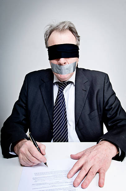 Gagged and Blindfolded Businessman Signing A Contract http://i895.photobucket.com/albums/ac158/jameswhittaker_bucket/iStockBanner2011WorkersMaster.jpg interroagtion stock pictures, royalty-free photos & images