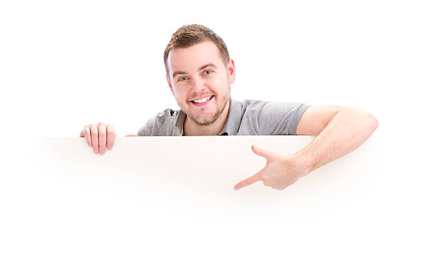 istock smiling young male holding sign 154952464