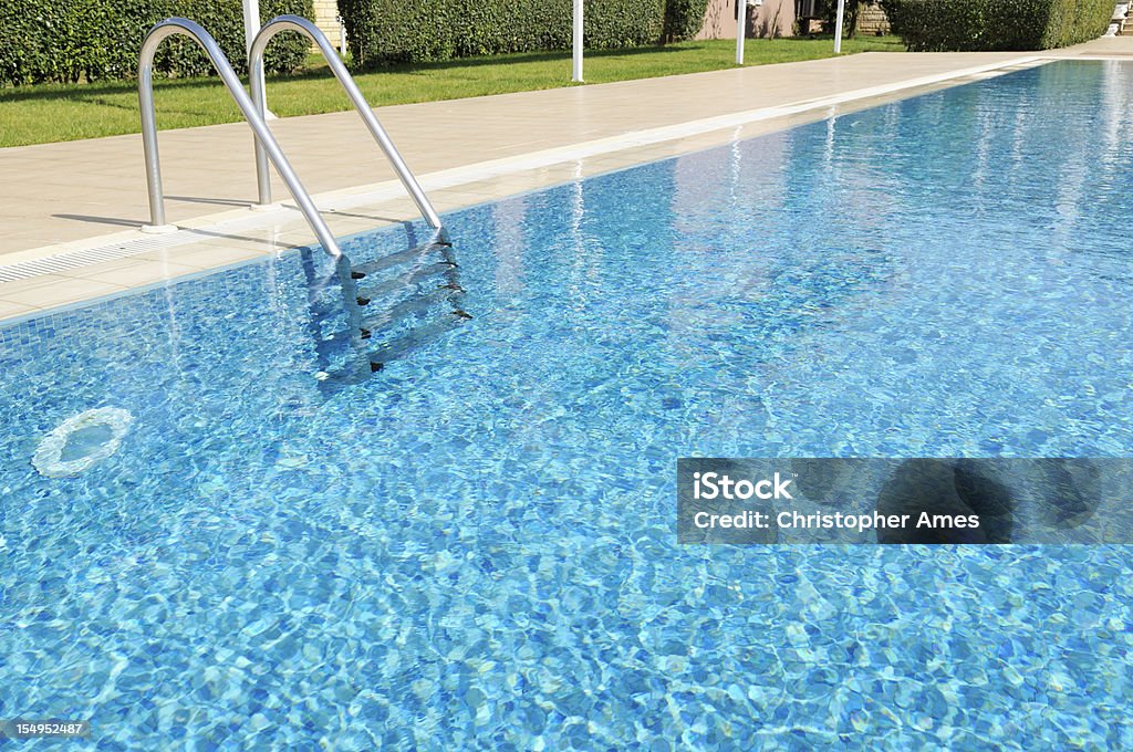 Beautiful Outdoor Hotel Swimming Pool in Sunshine It's a beautiful, sunny day and the swimming pool awaits. Swimming Pool Stock Photo