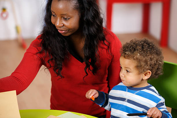 istock Mother/Carer/Childminder And Toddler Doing Artwork 154952491
