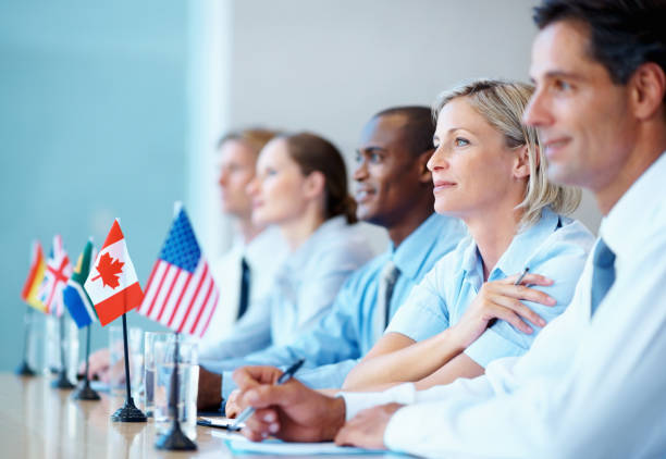 International business team in a meeting Multi ethnic international business team sitting in a row in meeting united nations stock pictures, royalty-free photos & images