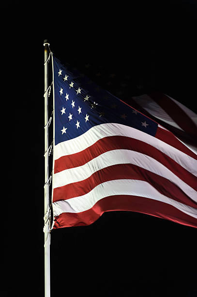 istock American Flag Flying at Night, Close Up on Black 154952929