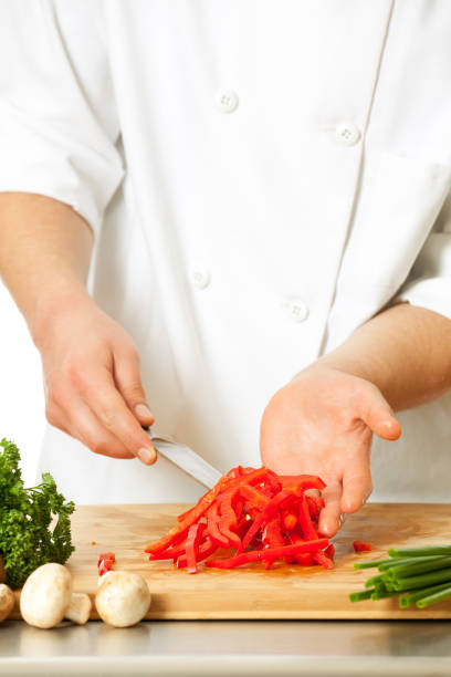 istock Hands of chef cutting a red bell pepper 154952963