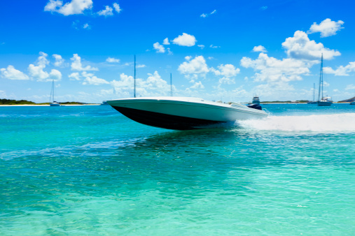 Power boat sailing at fast speed on a tropical turquoise bay. 