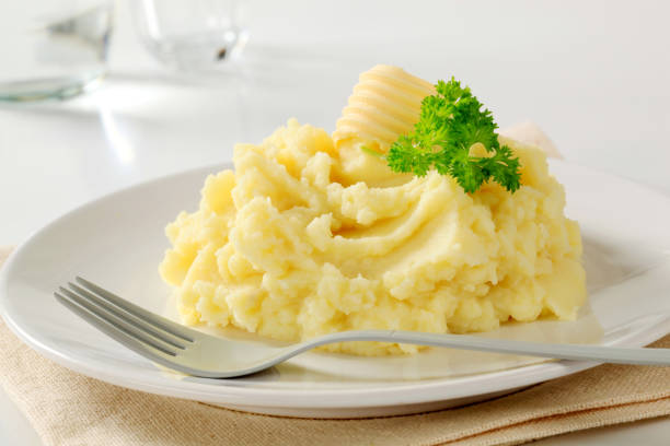 Close-up of mashed potatoes served on white ceramic plate