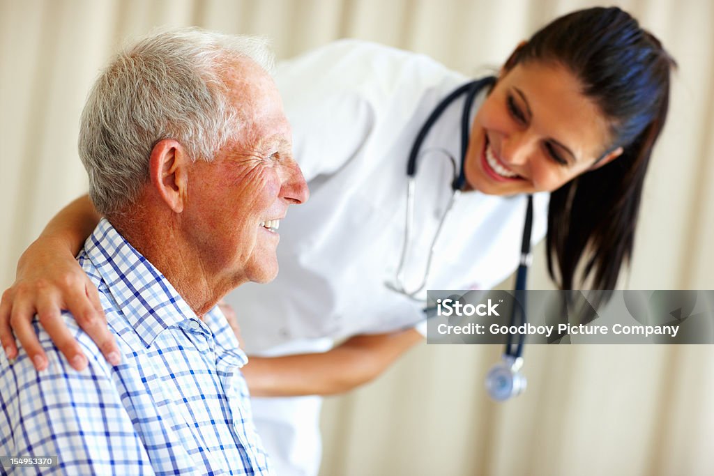 Doctor comforting senior man Female medical doctor comforting senior man 30-39 Years Stock Photo